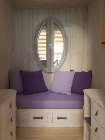 Kuschelige Sitznische mit violetten Kissen