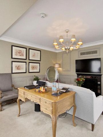 Elegantes Arbeitszimmer mit antikem Schreibtisch und Kamin