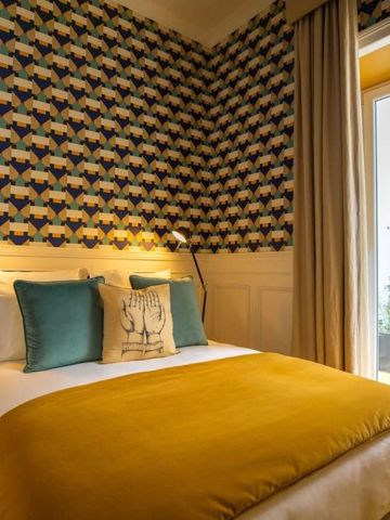 Schönes Zimmer mit eleganter Tapete und bequemer Sitzecke