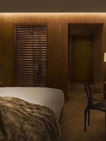 Elegantes Hotelzimmer mit gemütlicher Atmosphäre, Holzverkleidung und modernem Design