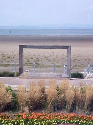 Küstenlandschaft mit Meerblick durch einen Holzrahmen