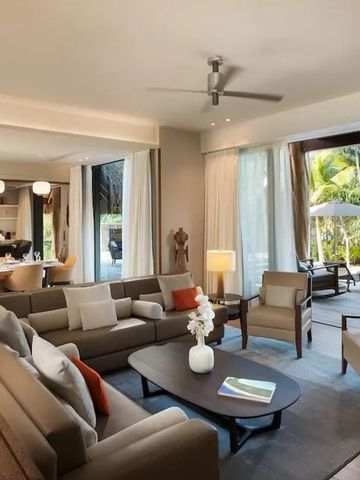 Helles Wohnzimmer einer Villa mit Terrasse und Gartenblick