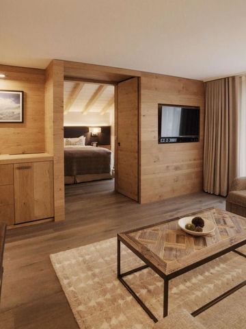 Geräumige Suite mit elegantem Wohnzimmer und modernen Holzelementen im Hotel The Capra Saas-Fee