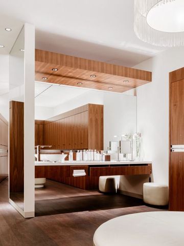 Geräumiges Badezimmer mit edlem Holzdesign und eleganter Beleuchtung