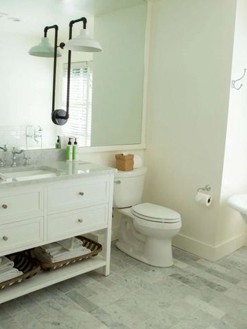 Elegantes Badezimmer mit freistehender Badewanne und großen Spiegeln