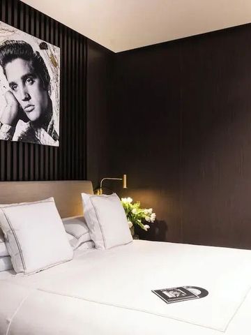 Modernes Hotelzimmer mit Kunst an der Wand und elegantem Doppelbett