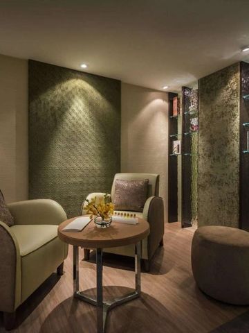 Intimer Spa-Raum mit bequemen Sitzmöglichkeiten und dezenter Beleuchtung