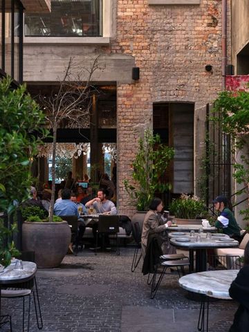 Gemütlicher Außenbereich des Restaurants mit Tischen und Pflanzen