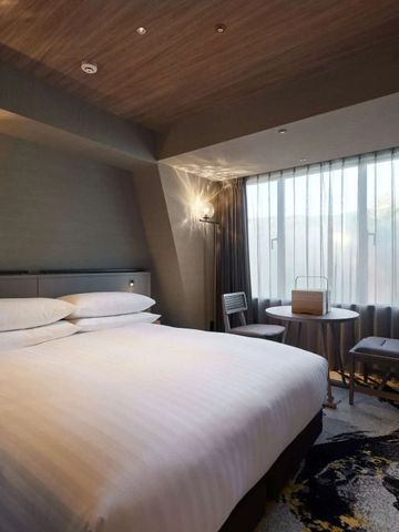 Elegantes Doppelzimmer mit modernem Design und großen Fenstern