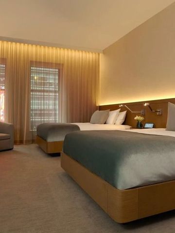 Modernes Doppelzimmer mit zwei Betten und sanfter Beleuchtung