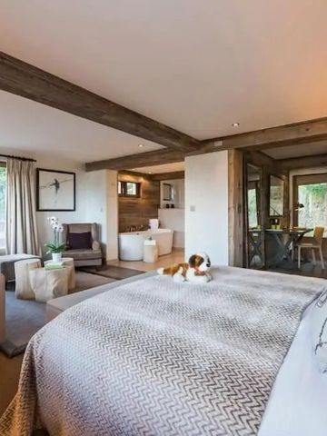 Luxuriöse Suite mit Holzdetails und großen Fenstern mit Bergblick