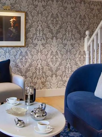 Luxuriöser Wohnbereich mit blauen Sesseln und Teetisch