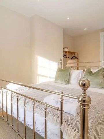 Elegantes Schlafzimmer mit Metallbett und großen Fenstern im Hotel The Middle House