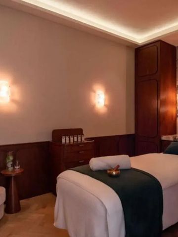 Bequemer Spa-Behandlungsraum mit gedämpfter Beleuchtung und eleganter Ausstattung