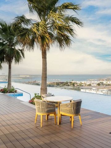 Infinity Pool mit Meerblick auf der Terrasse des Hotels und Palmen