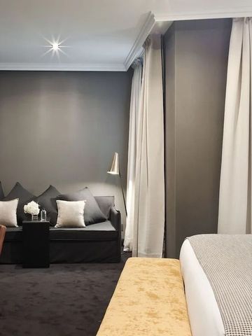 Hotelzimmer mit gemütlichen Sitzbereich und geschmackvoller Einrichtung.