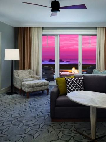 Wohnzimmer einer Suite mit Blick auf den Sonnenuntergang