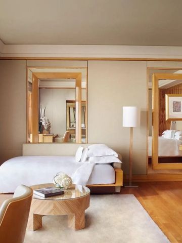 Elegantes Hotelzimmer mit modernen Holzakzenten und großen Spiegeln