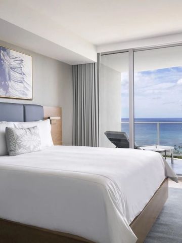 Luxuriöses Hotelzimmer mit großem Bett und Aussicht auf den Ozean