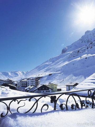 Winterliche Berglandschaft mit Blick auf verschneite Hütten und Berge