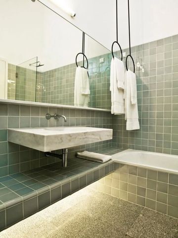 Modernes Badezimmer mit stilvollen Fliesen und großem Spiegel