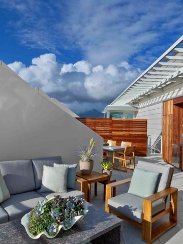 Elegante Dachterrasse mit Sitzbereich und Grillmöglichkeit unter blauem Himmel.