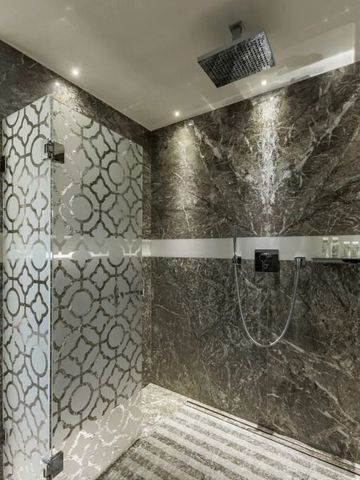 Edles Badezimmer mit Marmordekor und Regendusche