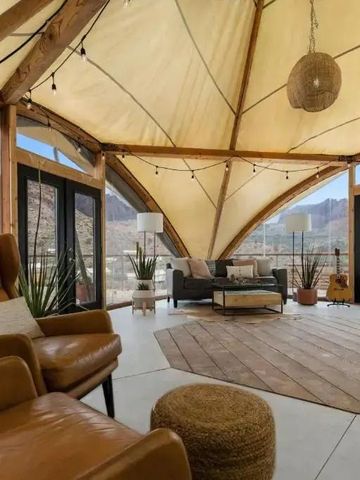 Heller Lounge-Bereich mit modernen Möbeln und Panoramafenstern mit Bergblick.