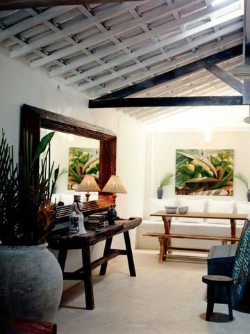 Elegantes Wohnzimmer mit Holzelementen und exotischen Pflanzen.