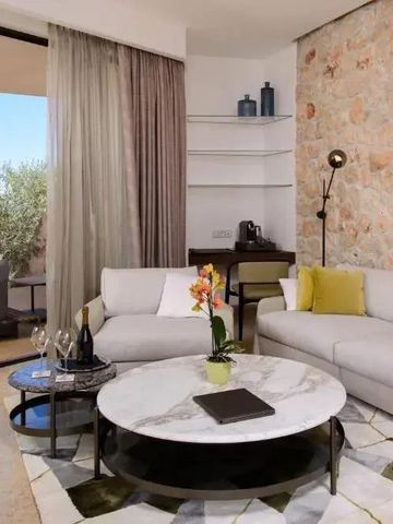 Elegantes Wohnzimmer mit Steinwand und Glasfront mit Blick in die Natur