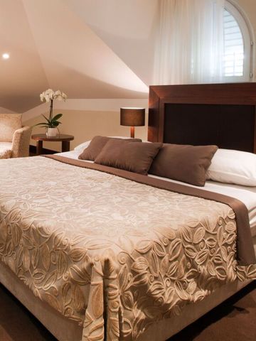 Gemütliches Schlafzimmer mit stilvoller Beleuchtung und eleganten Details