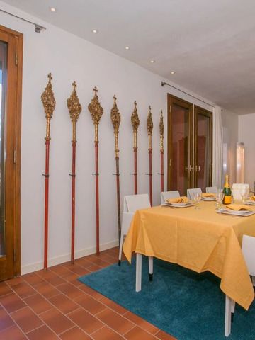 Esszimmer mit gedecktem Tisch, großen Fenstern und dekorativen Stäben an der Wand