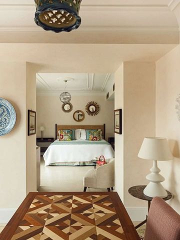 Essbereich mit kunstvoll gestaltetem Tisch und Blick auf das Schlafzimmer.