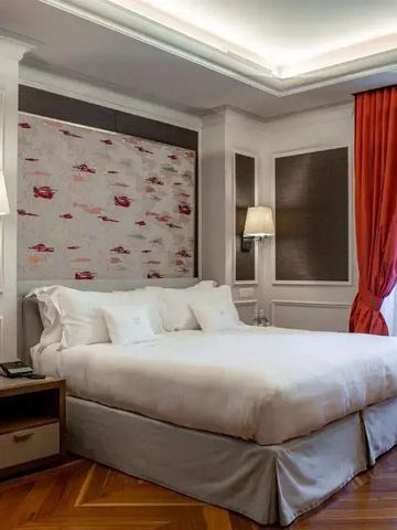 Luxuriöses Hotelzimmer mit elegantem Design und roten Vorhängen