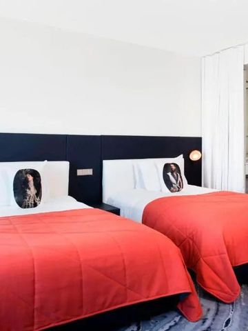 Zweibettzimmer mit roten Akzenten und eleganter Einrichtung im W Barcelona