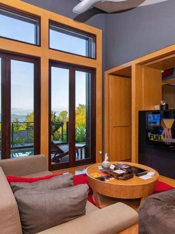 Wohnzimmer mit modernen Möbeln und großem Fenster mit Meerblick