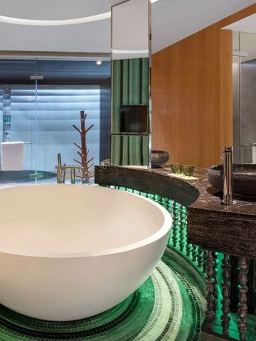 Modernes Badezimmer mit großer runder Badewanne und Designarmaturen