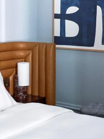 Detail eines luxuriösen Hotelzimmers mit einem modernen Kunstwerk an der Wand