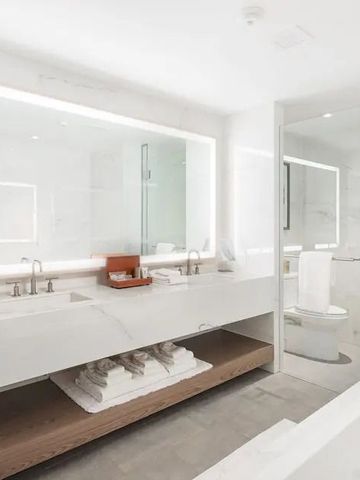 Modernes Badezimmer mit großen Spiegeln und eleganten Armaturen