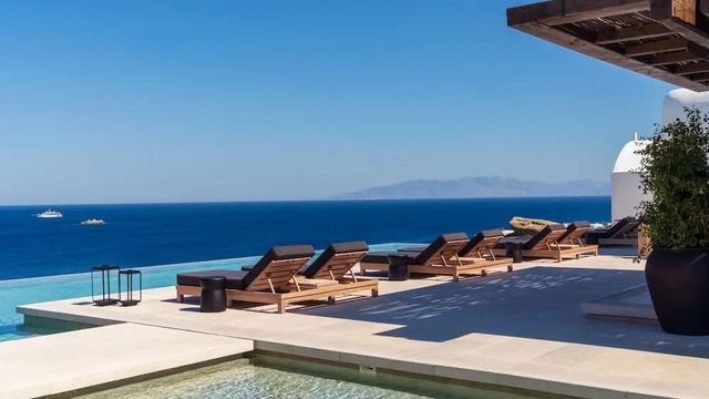 Sonnenliegen am Infinity-Pool mit Blick auf die Ägäis im Kalesma Mykonos 