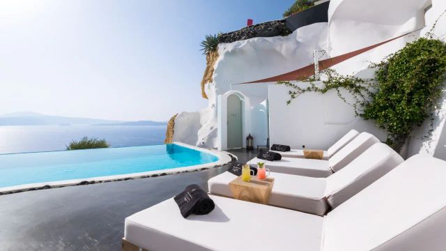 Andronis Luxury Suites Santorini Liegestühle und Pool mit Meerblick