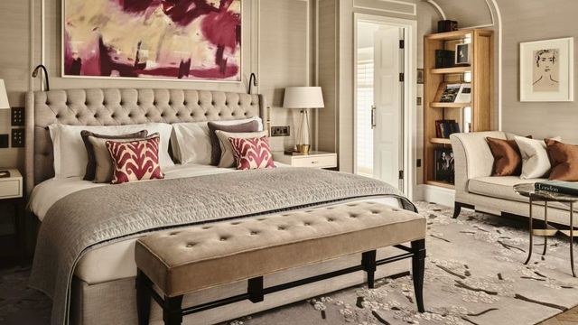 Geräumiges Schlafzimmer mit Designerbett und abstrakter Kunst.