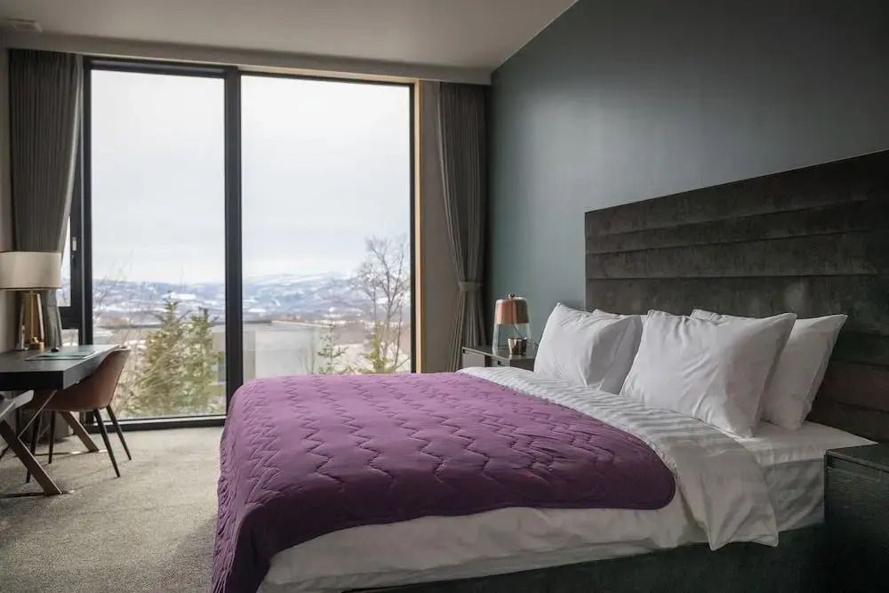 Komfortables Schlafzimmer mit moderner Einrichtung und Bergblick