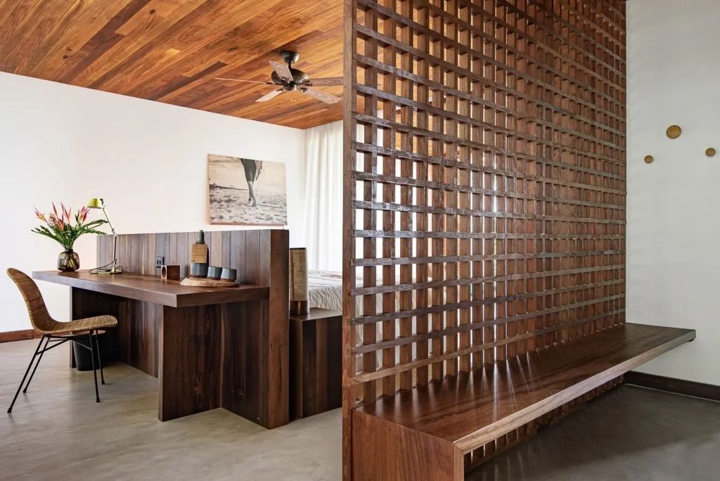 Modernes Hotelzimmerdesign mit Holzgitterelementen und elegantem Dekor.