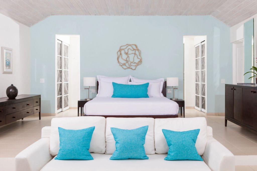 Geräumiges Schlafzimmer mit blauen Akzenten und eleganten Dekorationen