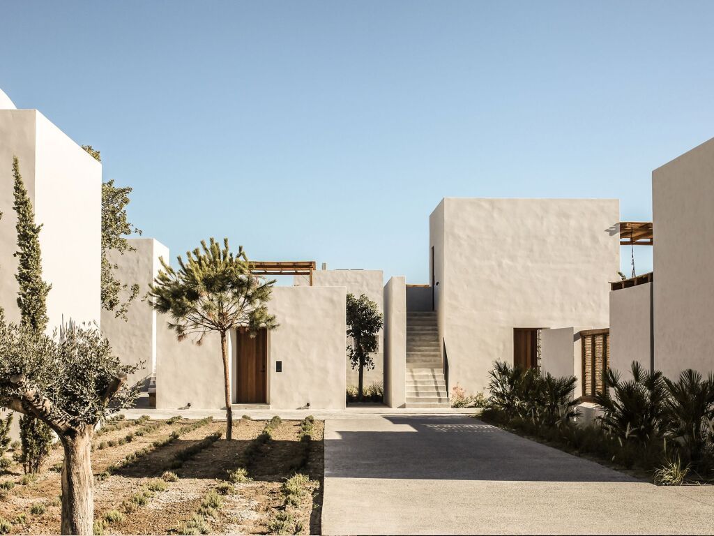 Minimalistische weiße Gebäude des OKU Kos Hotels mit klarem Himmel