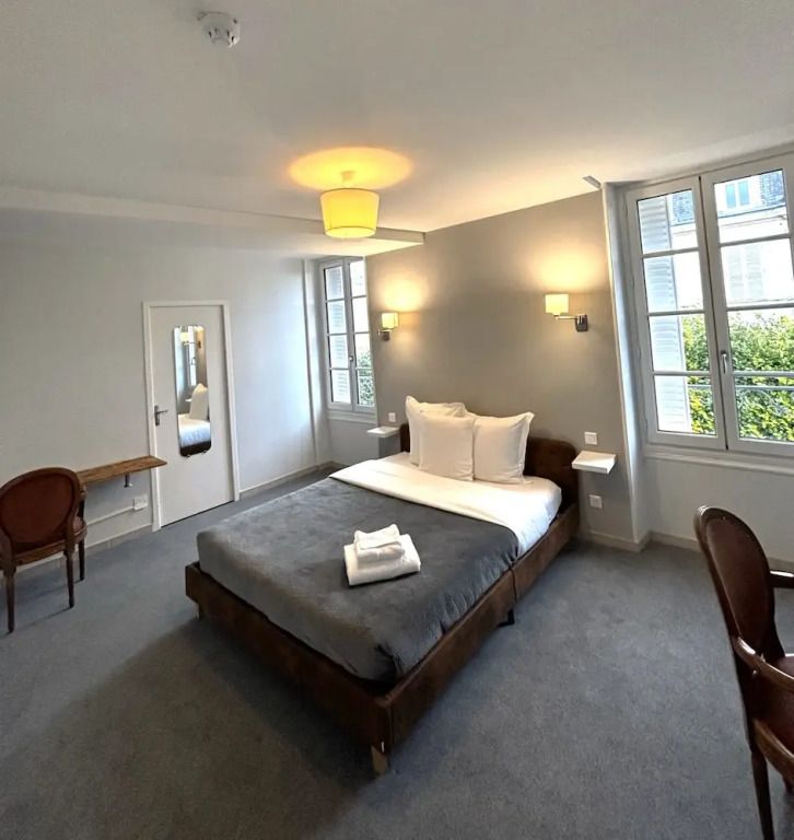 Großes, helles Zimmer mit Doppelbett. Zwei Fenster mit Blick ins Grüne.