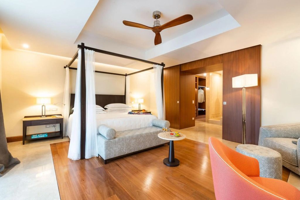 Elegantes Schlafzimmer mit Himmelbett, modernem Dekor und Holzboden