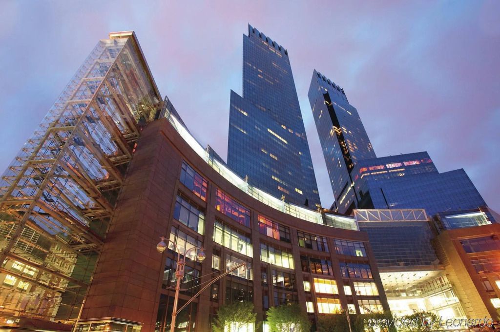 Zeitgenössisches Hochhausgebäude mit reflektierenden Glasfassaden bei Abenddämmerung