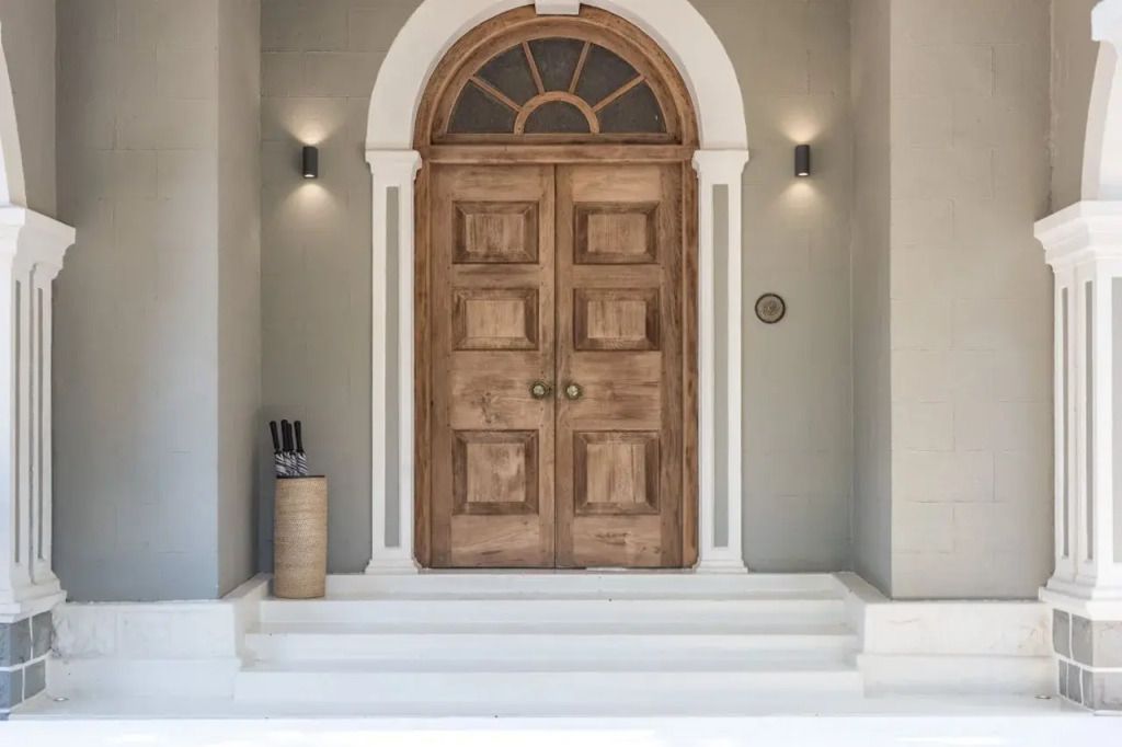 Eleganter Hoteleingang mit großen Holztüren und Treppe
